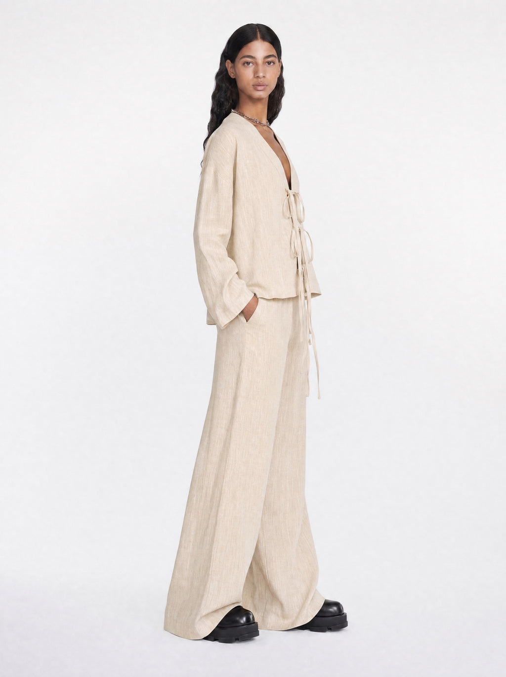 Woman wearing a beige outfit on a white background