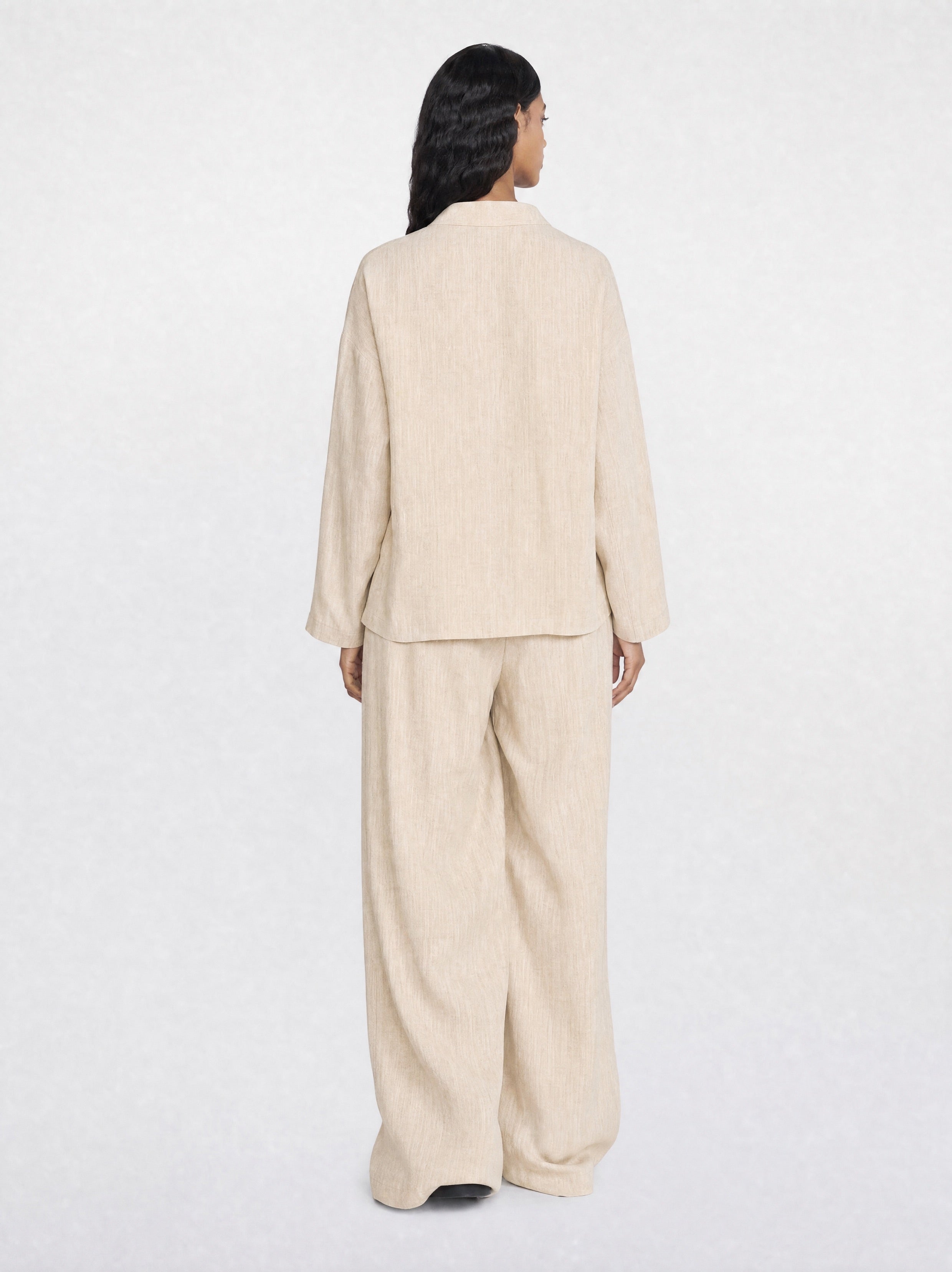 Woman wearing a beige suit on a white background